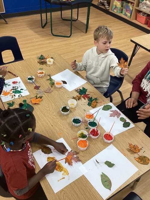 School age children creating fall art pieces