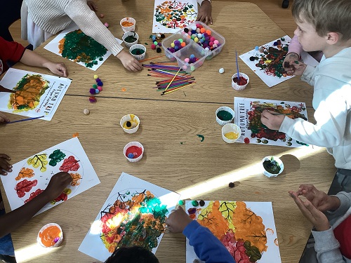School age children participating in a fall art experience