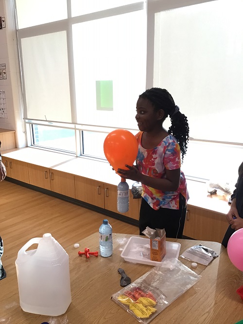 A school age child participating in a science experience