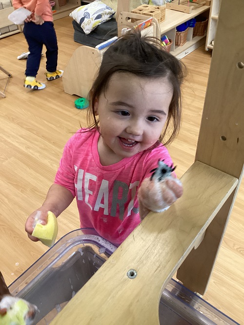 A toddler holding a Halloween gem