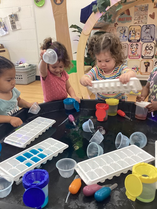 A group of toddlers colour mixing