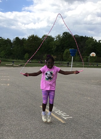 Child jumping while using a skipping rope