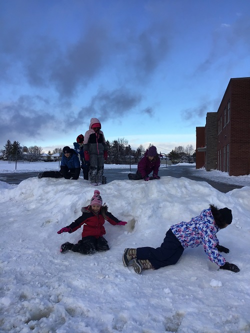 children outside on a snow hill