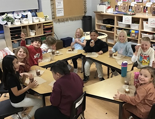 School-age children eating the treats they made