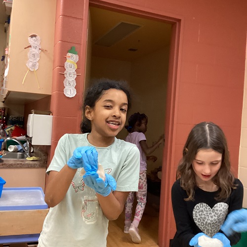 2 children making their dumplings