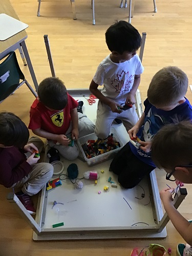 group of school age children creating zip lines