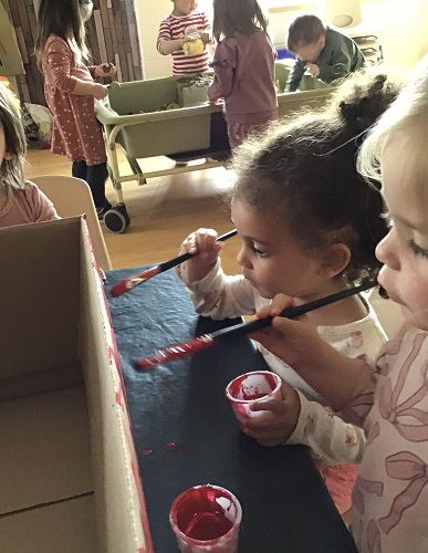 Painting the cardboard box red