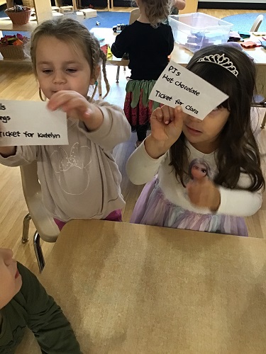 Children showing off their tickets