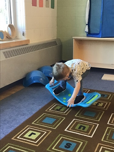 A child balancing on a balance board