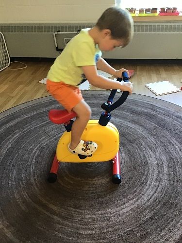 A child on a child sized exercise bike