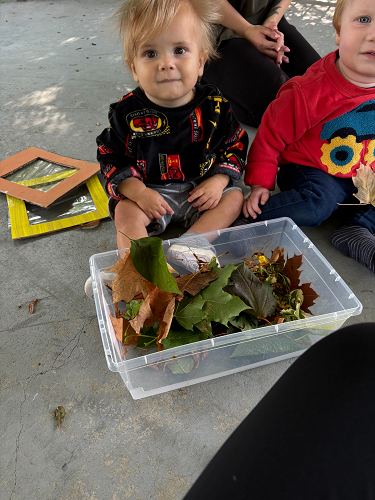Children sitting in the gazebo using nature items to create artwork
