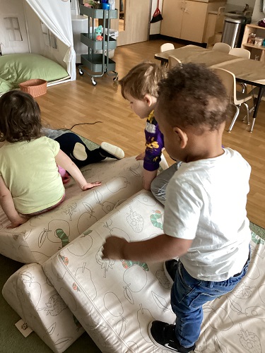 Children climbing up and sliding down the Nugget