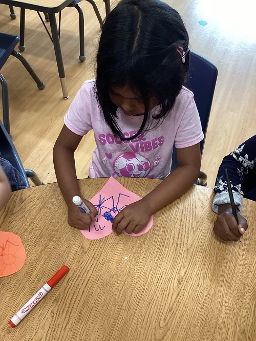 A school age child working on art