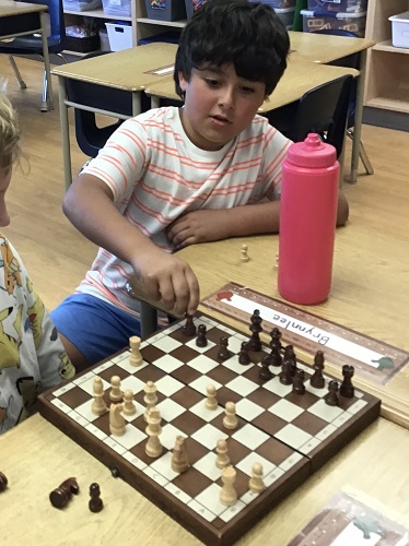 Two children playing chess