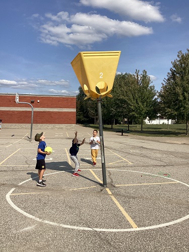 School-age boys playing bucket game 