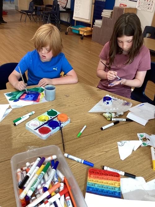 School age children working on art