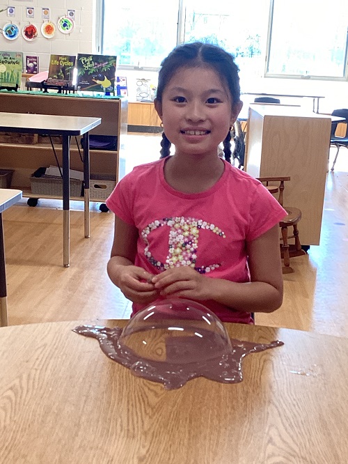 A school age child participating in a slime experience