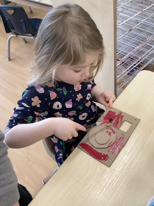 A child decorating a camera they created