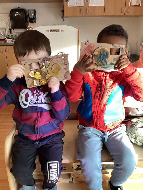 Two children taking pictures with their cameras