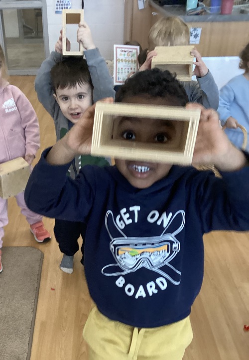 A child looking through their block camera