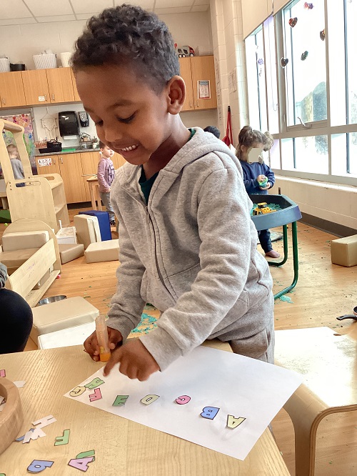 A child exploring with letters.