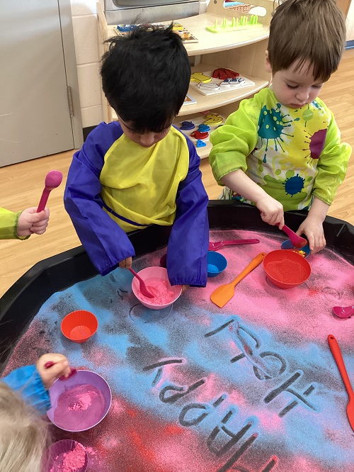Toddler children playing with colourful powder for Holi