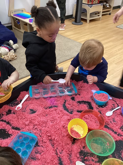 Children engaging with moon dough.