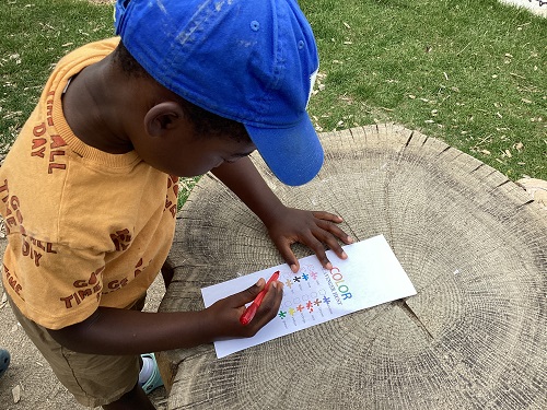 A child completing a scavenger hunt while outdoors.