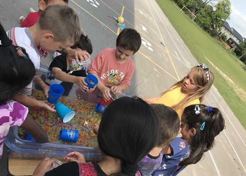 A group of children engage with exploration with Orbies.