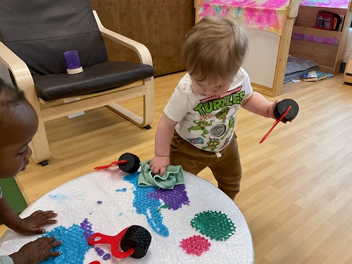 child wiping paint iwth a cloth