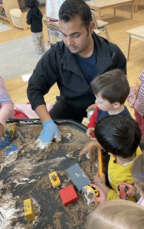 educator and child at tuff tray