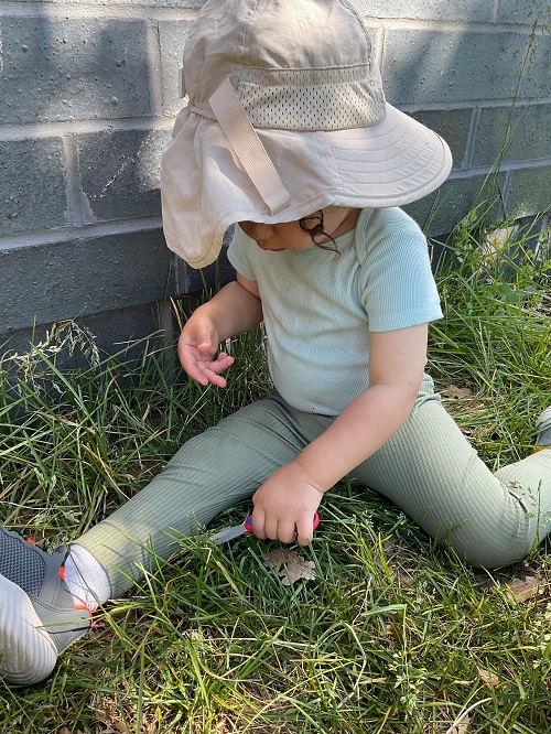 child cutting grass