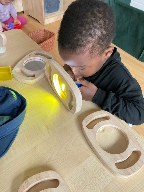 child with yellow magnifying glass