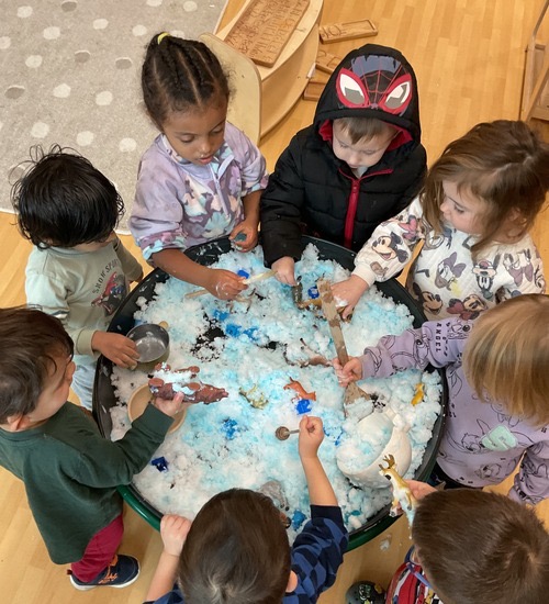 children gathering around the snow table