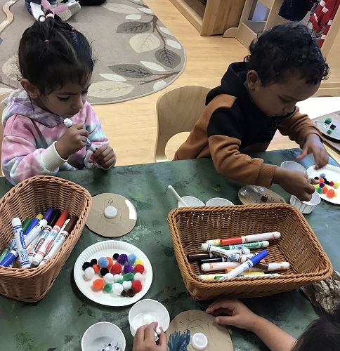 Children creating crafts at the table