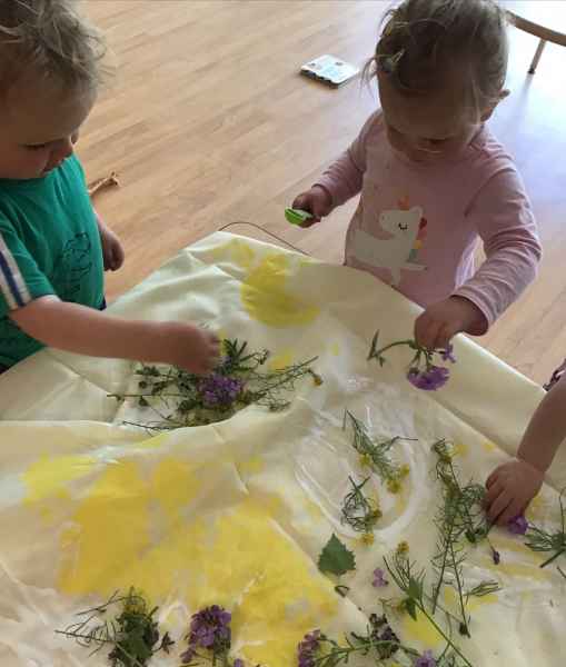 children painting with flowers
