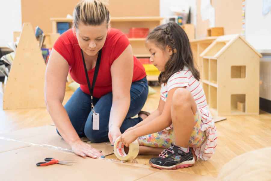 girl with educator tapin boxes together
