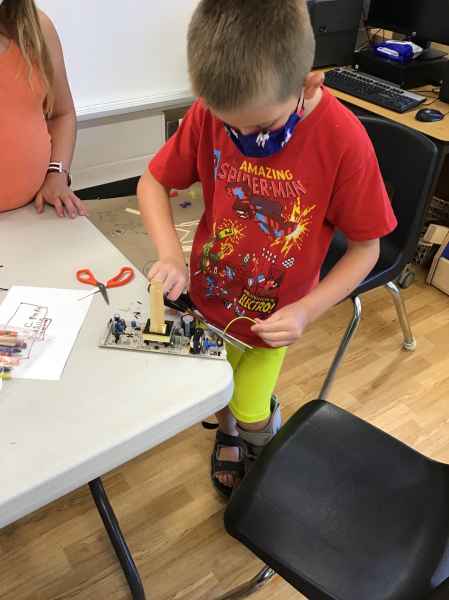 boy putting electronics together