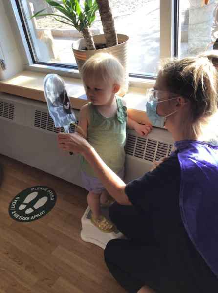 educator showing child their superhero photo