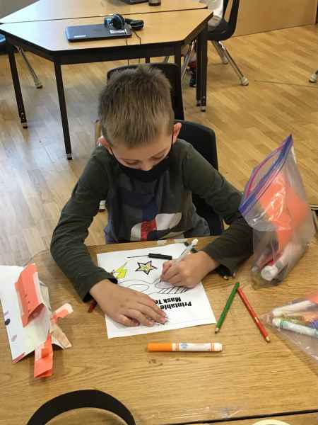 school-age boy colouring