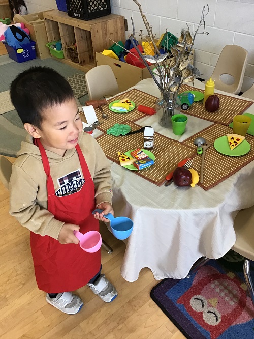 child engaging in restaurant dramatic play