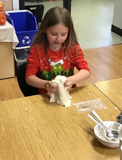child mixing dough