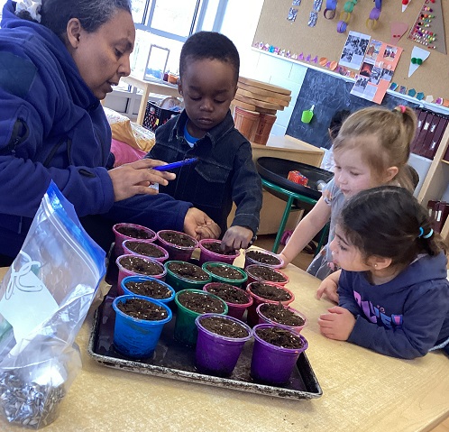 children picking plant pots