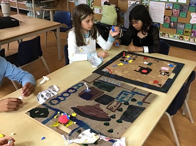 children playing a board game they made
