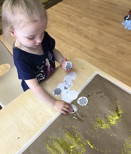 child doing a bee craft