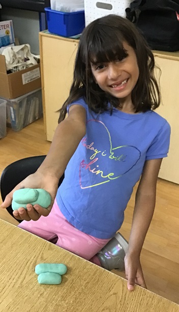 child playing with puffy dough
