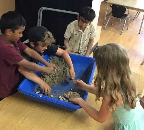 group of children playing with fluffy sensory sand