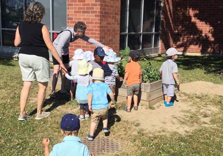 children observing our playground garden