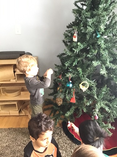 child decorating tree