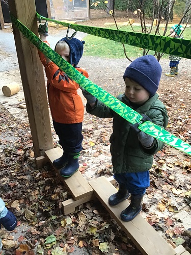 children holding onto ratchet straps